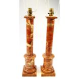 A pair of 20thC marble finish table lamps, each formed as classical columns in textured colours on