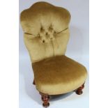 An Edwardian walnut framed nursing chair, in (later) green button back material on turned front