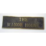 A part brass door plaque, reading The Manor House, with brass outline, of modern construction, 12.