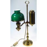 A 20thC brass table light, centred with a cylindrical carrying handle with green and white milk