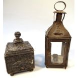 A late 19thC heavy metal tobacco jar, of square outline, the heavily cast removable lid opening to