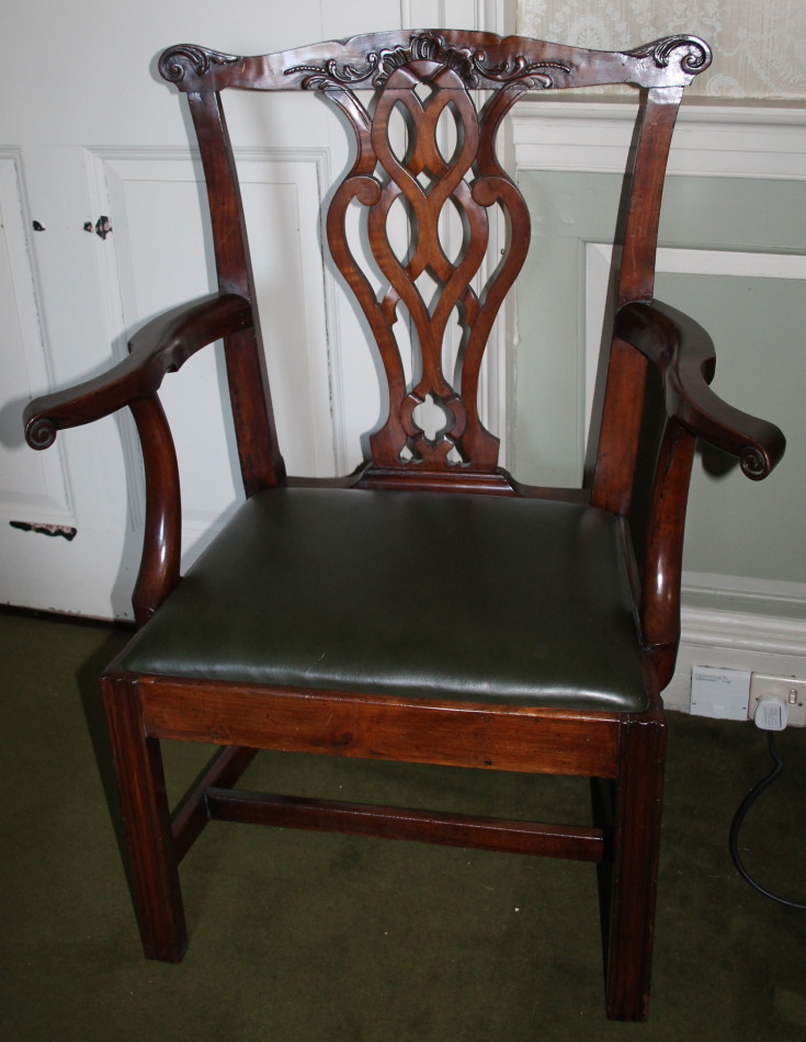 A late 18th/early 19thC country made fruitwood open armchair, with a carved rail, a pierced splat