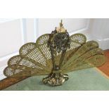 A brass fan shaped folding spark guard in 19thC style, with a turned finial on a shaped base, 67cm
