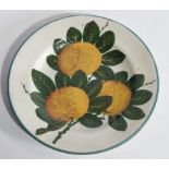A 19thC Wemyss Pottery side plate, the circular body hand painted with fruit in orange and green,