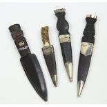 Four dirks, with silver or white metal mounts, horn or bog oak handles, various sizes.