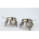 A pair of Victorian silver circular salts, of squat conical form and on three feet, engraved with