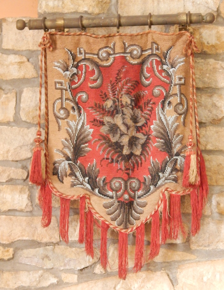 A Victorian beadwork pennant screen, on a red ground, with brass wall bar, 49cm high.