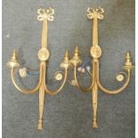 A pair of Sheraton style brass wall lights, with ribbon and oval patera decoration, each with two