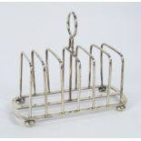 A George V silver seven-bar toast rack, by Hukin & Heath, Birmingham 1913, with a ring handle to