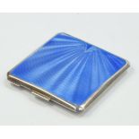 A George V silver powder compact by Mappin & Webb, with a mid blue guilloche enamel lid, mirror to