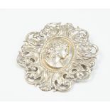 A rococo design brooch, cast in white metal, unmarked.