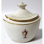 An early 19thC porcelain sucrier, the shaped body centred by an urn with gilt highlights and