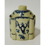 An 18thC pottery blue and white tea caddy, the shaped body with plain cylindrical top in a Neo-