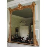 A 19thC gilt gesso overmantel mirror, the crest decorated with a Neo-Classical bust, surrounded by