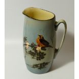 An early 20thC Royal Doulton jug, the cylindrical body decorated with a bird on a tree bough