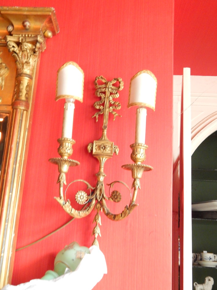 A pair of wall lights, with acanthus boss and pineapple finial.