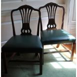 A pair of George III mahogany side chairs, each with a bellflower and patera carved crest rail above