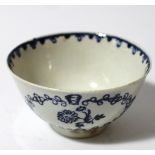 An 18thC blue and white porcelain tea bowl, the cylindrical body decorated with panels of flowers,