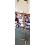 A 20thC brass floor lamp, in Art Nouveau style with cylindrical column, with square section supports