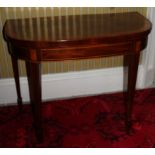 A George III mahogany and satinwood demi-lune card table, the top with a broad crossband with