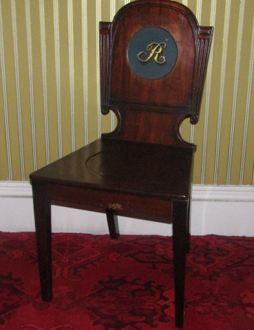 A George IV mahogany hall chair, the shaped back painted to the centre with the letter 'R', with a