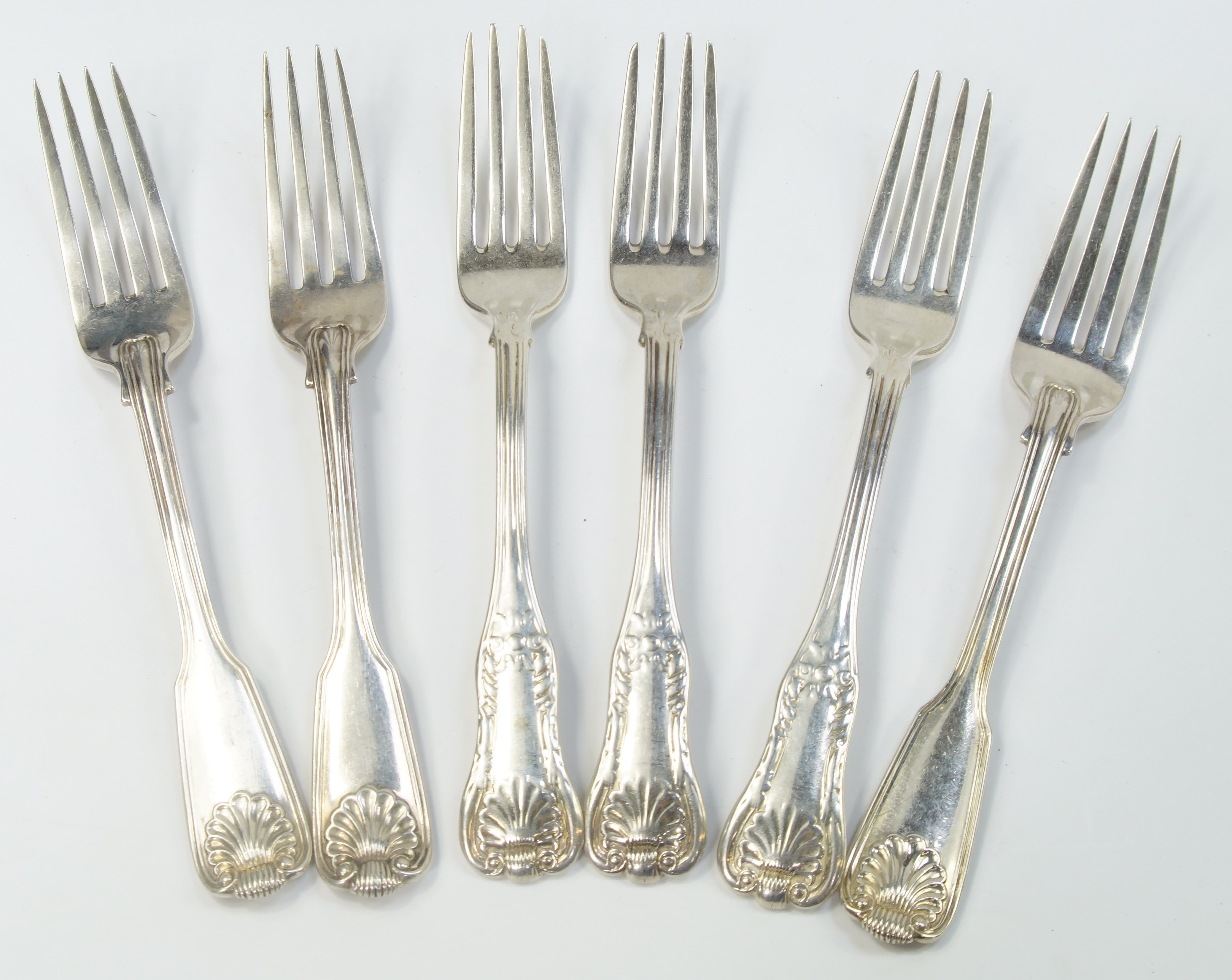 A set of three Victorian silver table forks, decorated in the fiddle, thread and shell pattern,