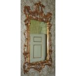 A pair of gilt wall mirrors in the Chinese Chippendale style, each elaborately decorated with a