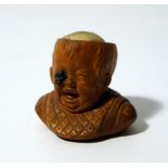 A 19thC French terracotta dolls's head, formed as a child with a fly in their eye, with material