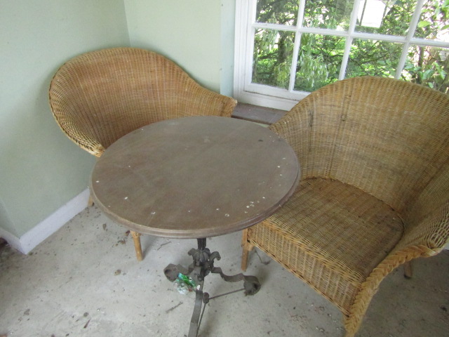 The contents of the tower, being a Victorian cast iron pedestal table, a pair of wicker conservatory