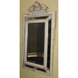 A Continental gilt gesso and painted wall mirror, the top with a broken pediment centred with a