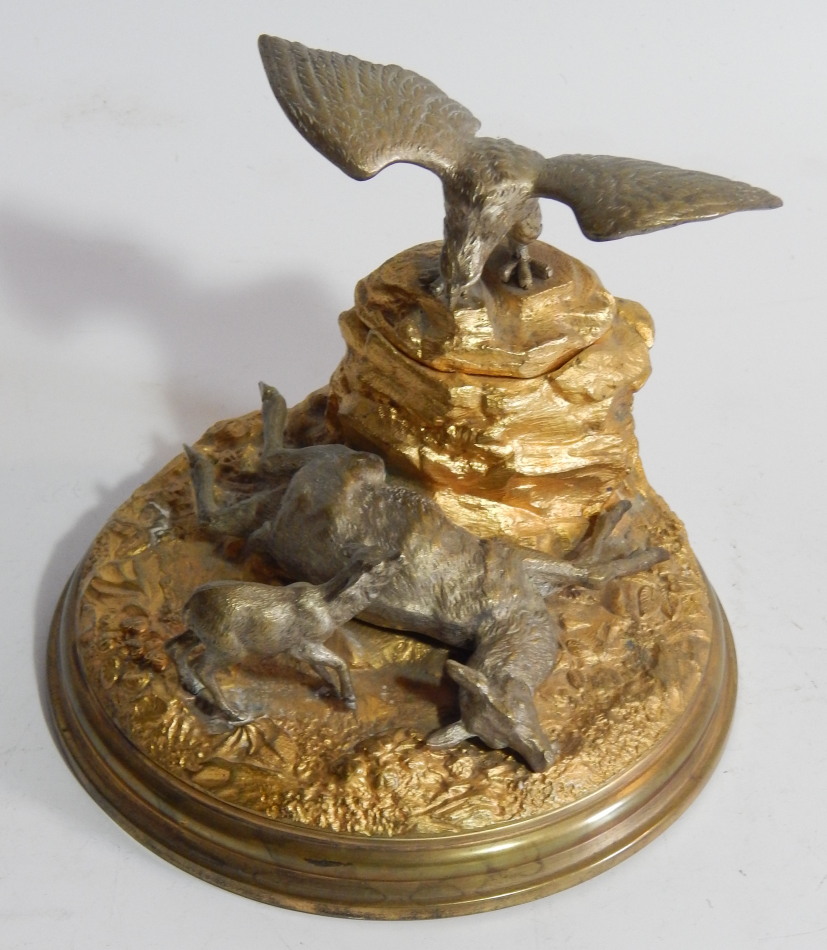 A 19thC French silvered and gilt bronze inkstand, in the form of an eagle on a rocky mound