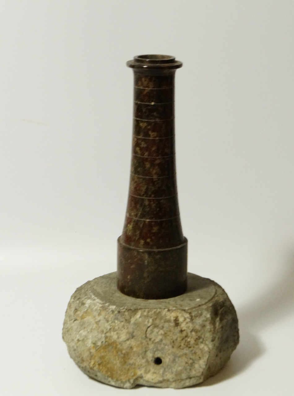 A serpentine model lighthouse table lamp, with rock base, 37cm high.