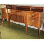 A George III mahogany serpentine fronted sideboard, with raised back and an arrangement of three