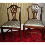 A pair of George III mahogany side chairs, each with a pierced back, a drop in seat on chamfered