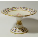 A 19thC semi porcelain comport, with a shaped outline with gilt highlights, centred by hand