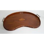 A Sheraton revival mahogany serving tray, of kidney shape, with satinwood inlaid shell, 60cm wide.