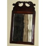 A small 18thC mahogany fret frame wall mirror, with a pierced crest and a moulded frame, 33cm