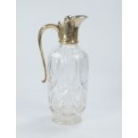 A cut crystal claret jug, with silver handle and mounts, London assay.