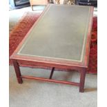 A mahogany coffee table, the rectangular top with a green leather insert and a moulded edge on