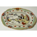 A 19thC Mason's Ironstone meat plate, the shaped oval outline centred with an Oriental scene of