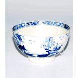 An 18thC blue and white porcelain tea bowl, decorated with trees, birds and houses, with an inner