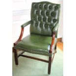 A mahogany Gainsborough type open armchair, upholstered in button green leather with studded