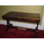 A William IV rosewood library table, the rectangular top with a beaded edge on tapering end supports