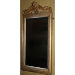A 19thC gilt gesso wall mirror, with a 'C' scroll and floral crest above a moulded frame with
