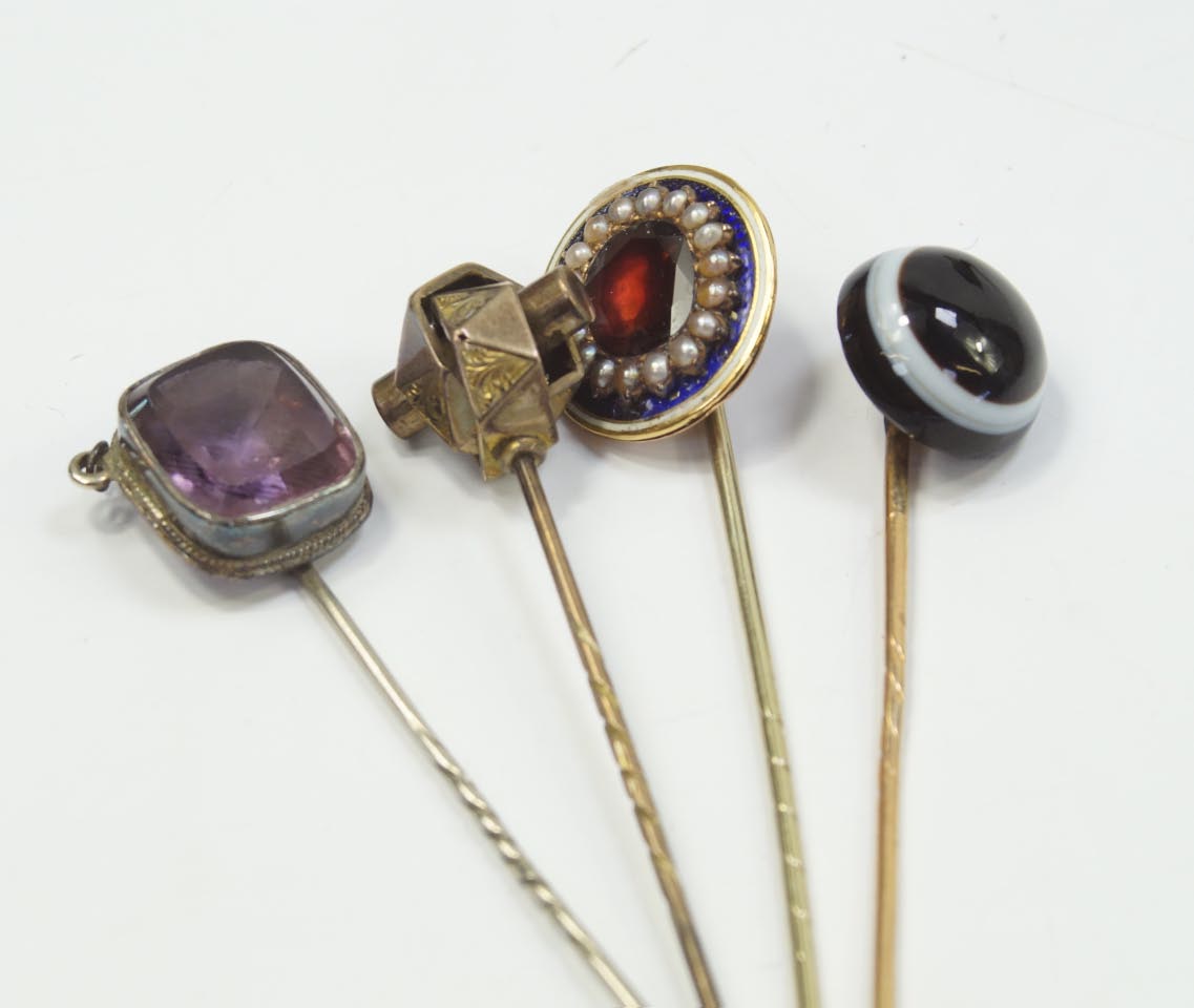 A Victorian bull's eye agate stick pin, and three other examples, (4).