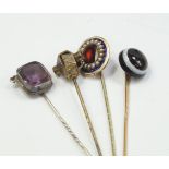 A Victorian bull's eye agate stick pin, and three other examples, (4).