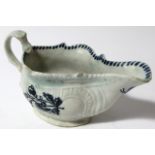 An 18thC blue and white porcelain sauceboat, of cape outline, the textured body decorated with