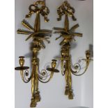 A pair of early 19thC giltwood and gesso wall lights, each carved with a central eagle, bows, arrows