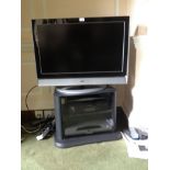 A JVC colour TV, DVD & VHS players and stand.