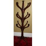 An early 19thC mahogany hat or coat stand, with central turned support and twelve shaped arms on